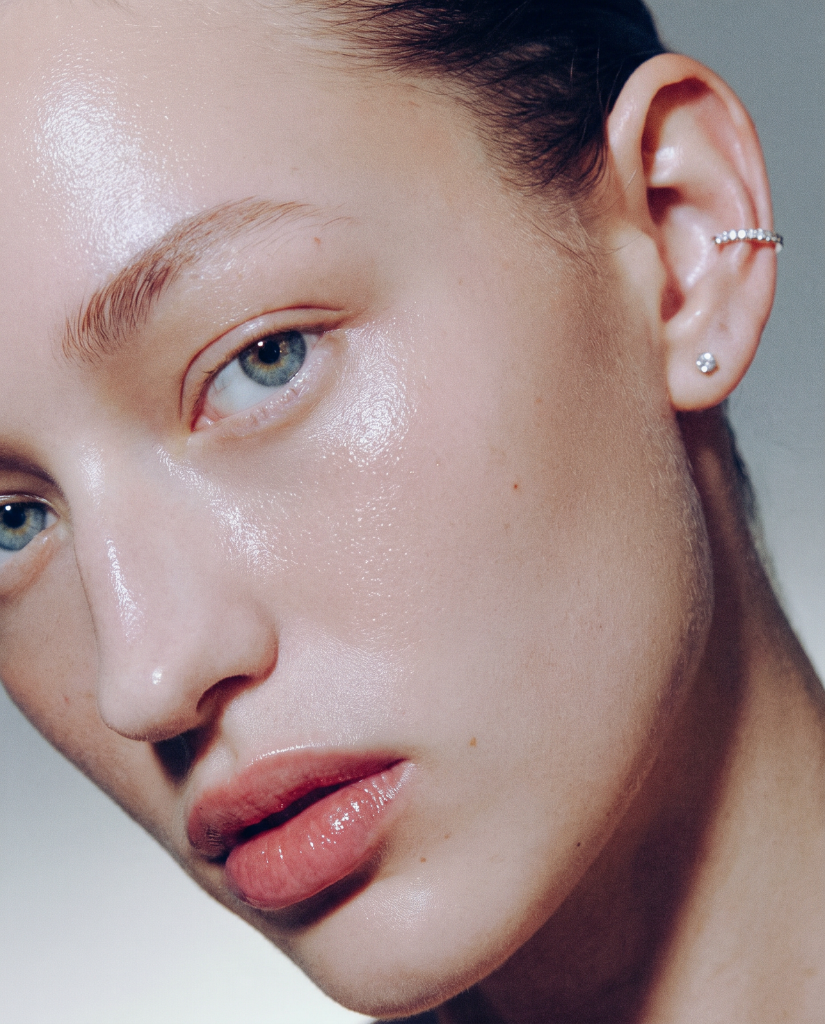 A close-up of an earring worn on the ear