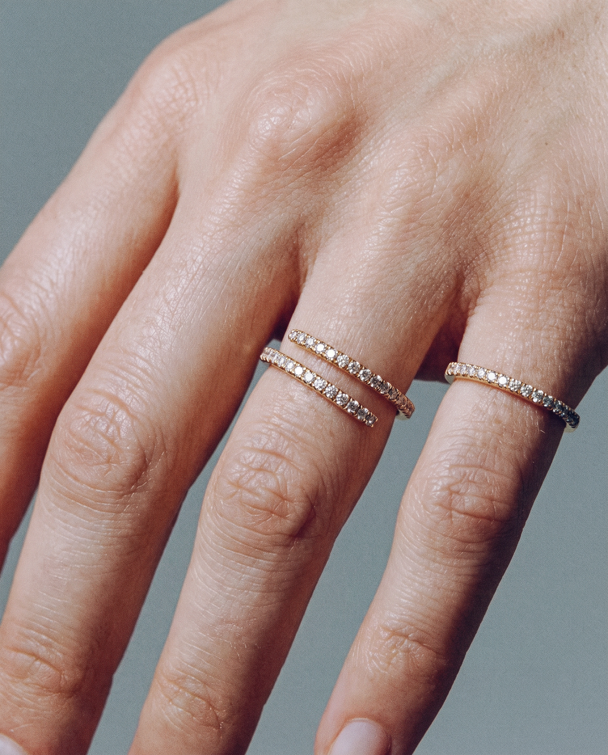 A close-up of rings worn on the hand